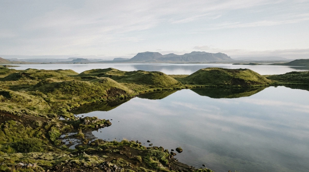 Green pseudo-craters and shallow water along the south shore of Lake Myvatn in northeast Iceland on a clear summer morning
